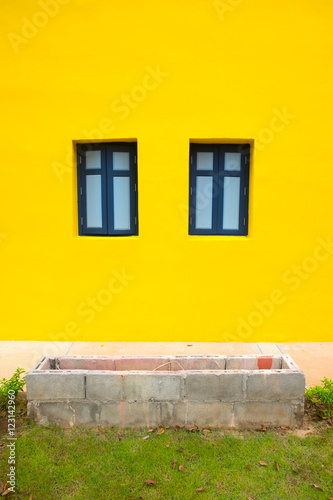 Empty wood window on yellow wall © Dontree