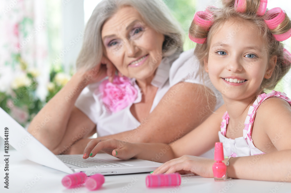 little girl   with granny using laptop