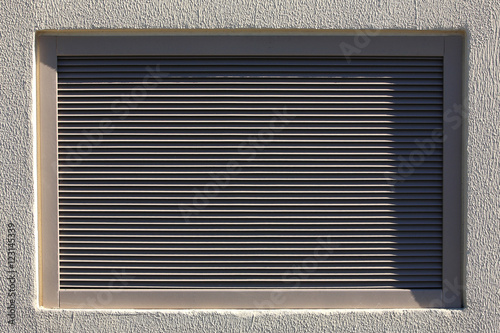 Metal blinds in the plastered wall