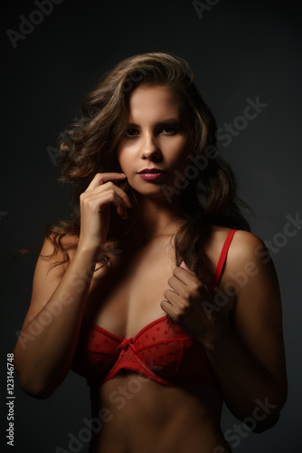 Erotica. Sexy woman in red bra looking at camera © Wisky