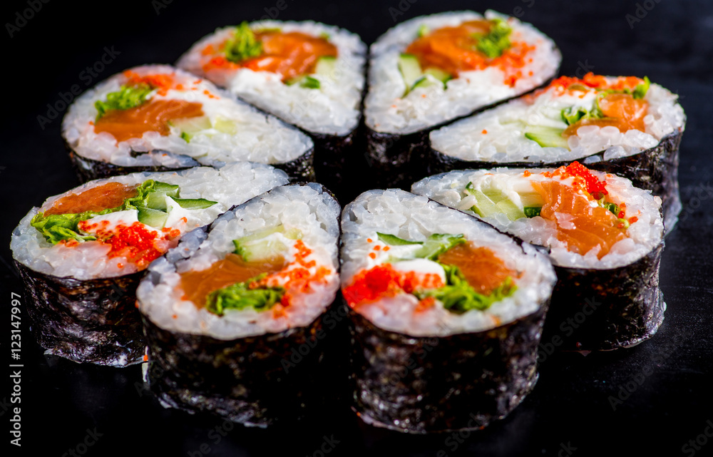 Japanese rolls with fish on a black background Japanese rolls with fish on a black background