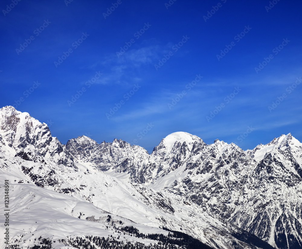 Snow mountains and blue sky in winter at sun day