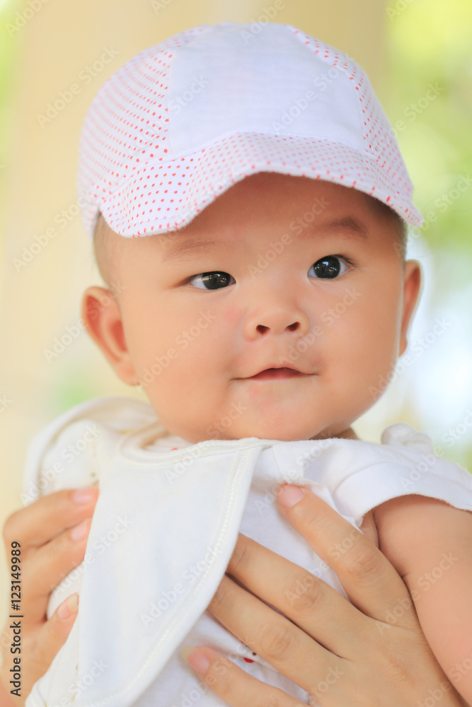 Asian baby in a mom hand and smile with happily. Asian baby in a mom hand and smile with happily.