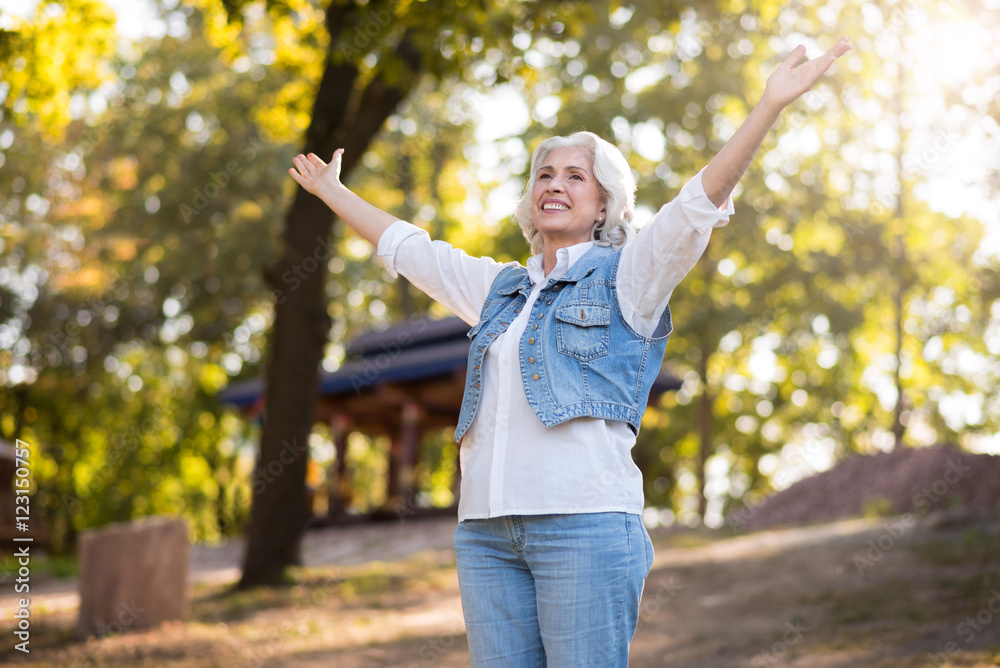 Beautiful elderly woman smiling and lifting arms. Beautiful elderly woman smiling and lifting arms.