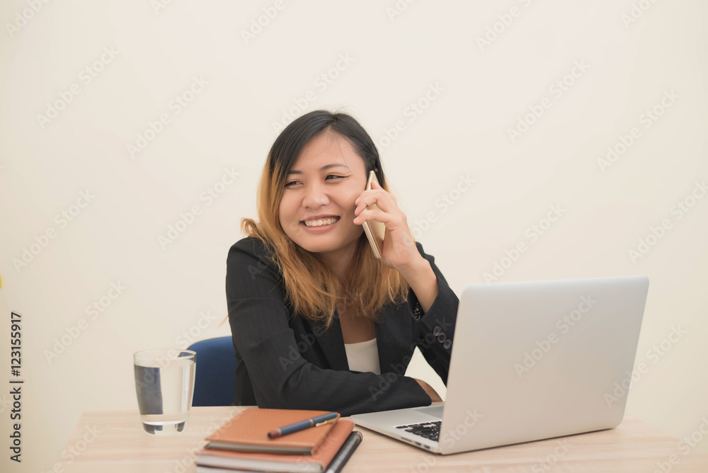 young business woman sitting at workplace and telephone conversa young business woman sitting at workplace and telephone conversa