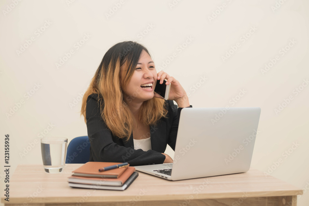 young business woman sitting at workplace and telephone conversa young business woman sitting at workplace and telephone conversa