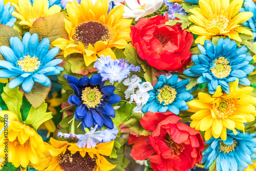 Closeup of Ukrainian colored blue and yellow fake cloth sunflowers