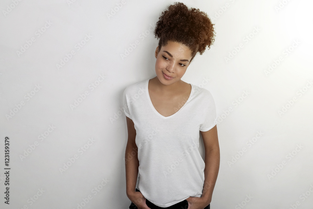 Studio portrait of a beautiful young African American woman against a bright background Studio portrait of a beautiful young African American woman against a bright background