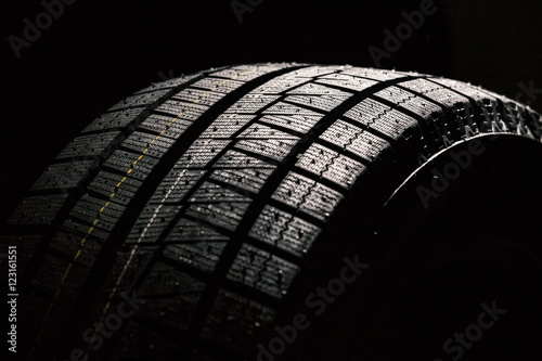 Winter Tire On Black Background photo