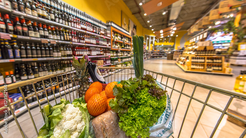 Photography Supermarket cart filled  with healthy products