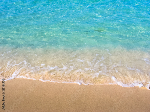 Close up of tropical and clear water of the Caribbean beach of Canto de la Playa, Saona Island, Dominican Republic. Sea and shore background. Concept of summer and Caribbean vacations.