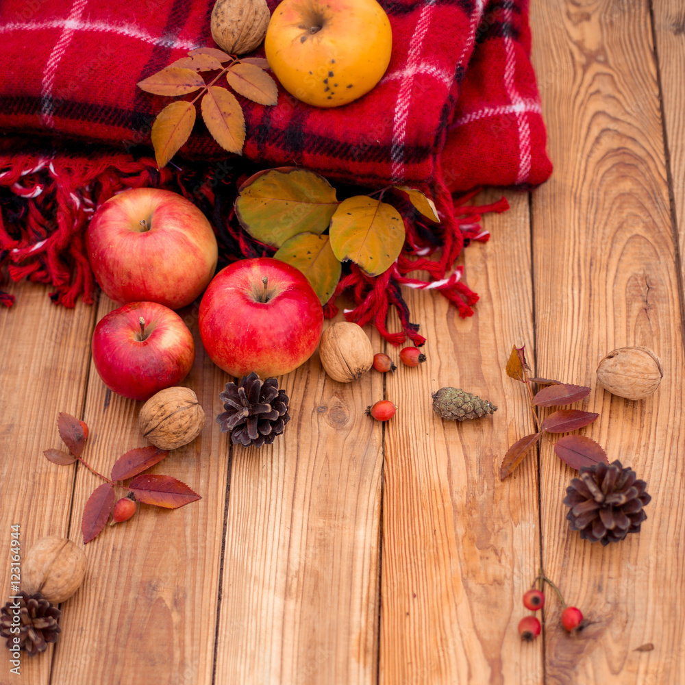 Autumn composition on a wooden background. Still life, food and drink, apples, pumpkin, nuts, cone, tea. Autumn composition on a wooden background. Still life, food and drink, apples, pumpkin, nuts, cone, tea.