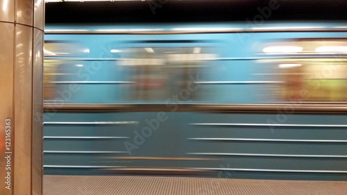 Rapid metro train moving across empty station