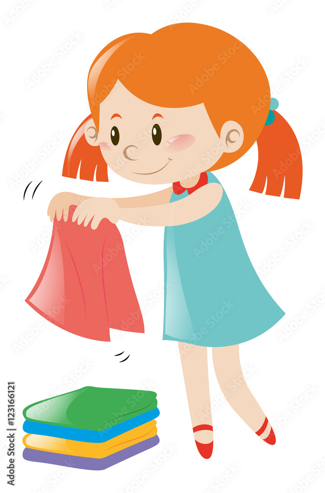Little girl in blue dress folding clothes Little girl in blue dress folding clothes