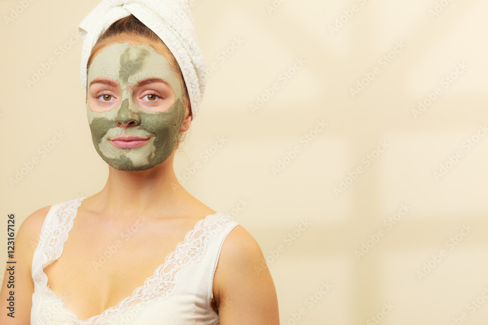 Woman face with green clay mud mask Woman face with green clay mud mask