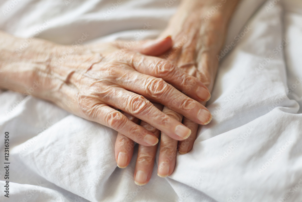 Seniors hands in bed Seniors hands in bed