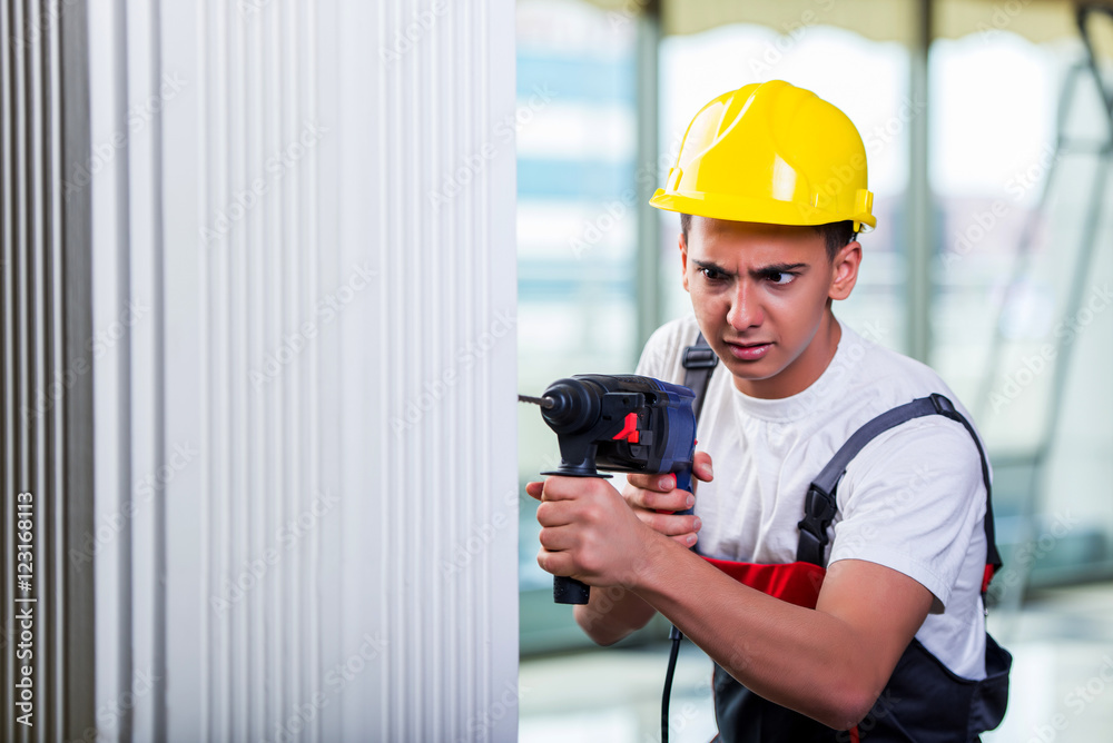 Man drilling the wall with drill perforator Man drilling the wall with drill perforator
