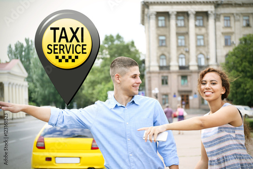Young couple stopping taxi ...
