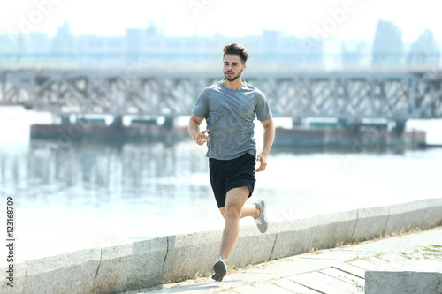 Fototapeta Naklejka Na Ścianę i Meble -  Young man jogging outdoors