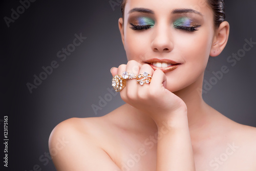 Beautiful woman showing off her jewellery in fashion concept