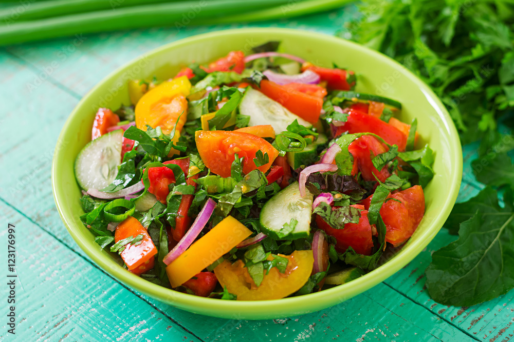 Fresh salad of tomatoes, cucumbers, peppers, arugula and red onion Fresh salad of tomatoes, cucumbers, peppers, arugula and red onion