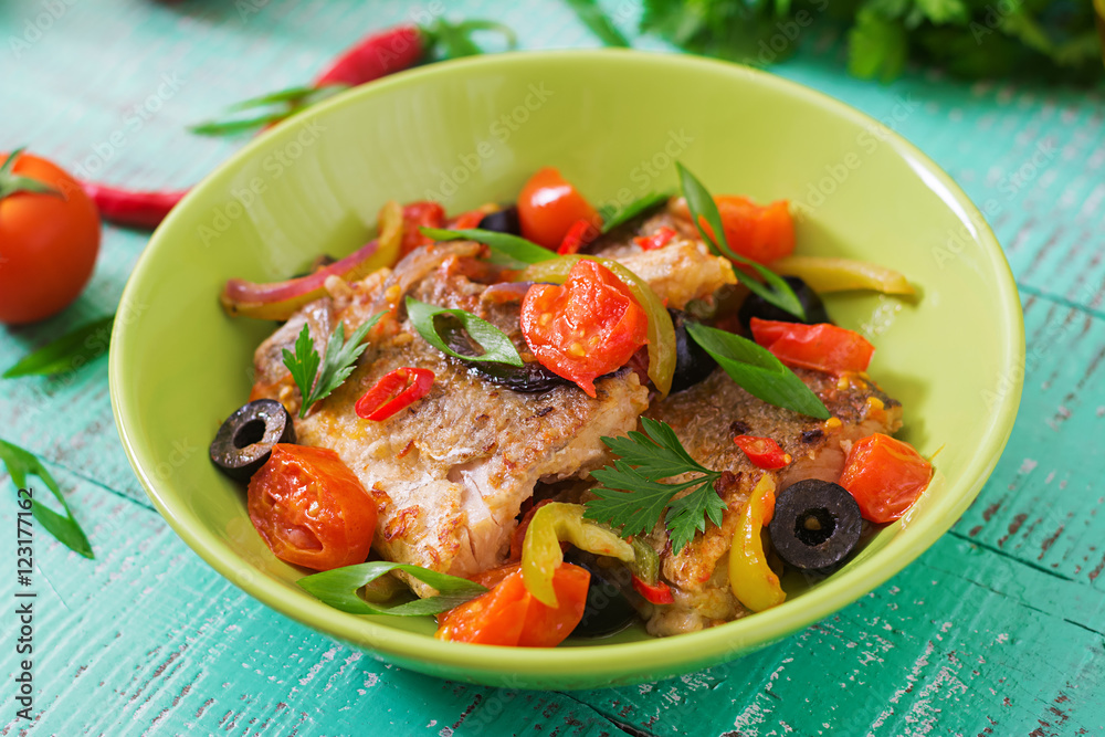 Fried hake fillet with tomato and olives in the Mediterranean style Fried hake fillet with tomato and olives in the Mediterranean style