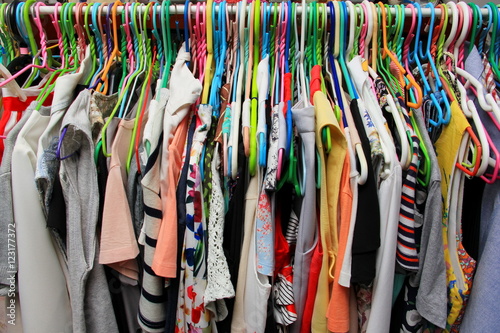 Colorful shirt on hanger, clothing on shelf