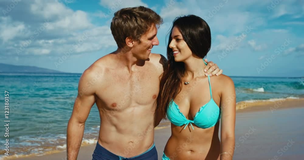 Happy romantic young couple walking and playing on the beach Happy romantic young couple walking and playing on the beach