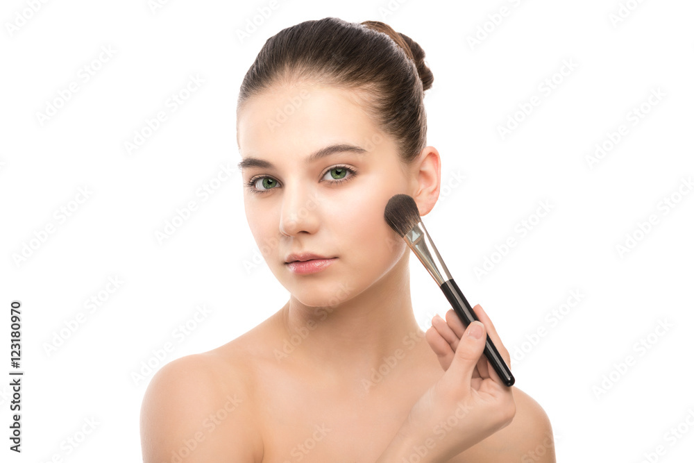 Portrait of beautiful young brunette woman with clean face. Beauty spa model girl with perfect fresh clean skin applying cosmetic brush. Youth and skin care concept. Isolated on a white background. Portrait of beautiful young brunette woman with clean face. Beauty spa model girl with perfect fresh clean skin applying cosmetic brush. Youth and skin care concept. Isolated on a white background.