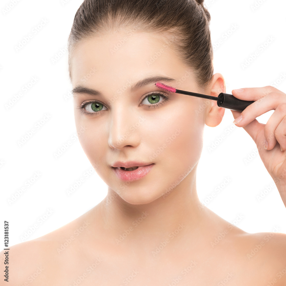 Eye make up apply. Mascara applying closeup, long lashes. Mascara brush. Portrait of beautiful young brunette woman with perfect fresh clean face skin. Eyelashes extensions. Make-up for green eyes Eye make up apply. Mascara applying closeup, long lashes. Mascara brush. Portrait of beautiful young brunette woman with perfect fresh clean face skin. Eyelashes extensions. Make-up for green eyes