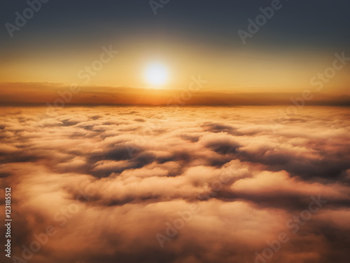 Flying above the clouds, sun is rising up