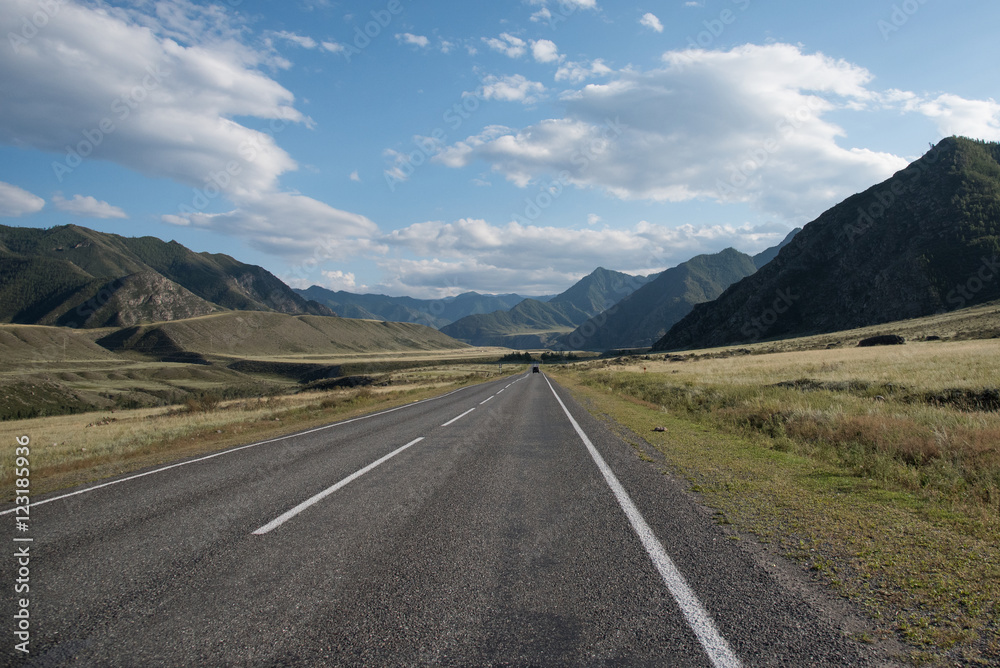 Asphalt winding road in the mountainous area in the summer and s