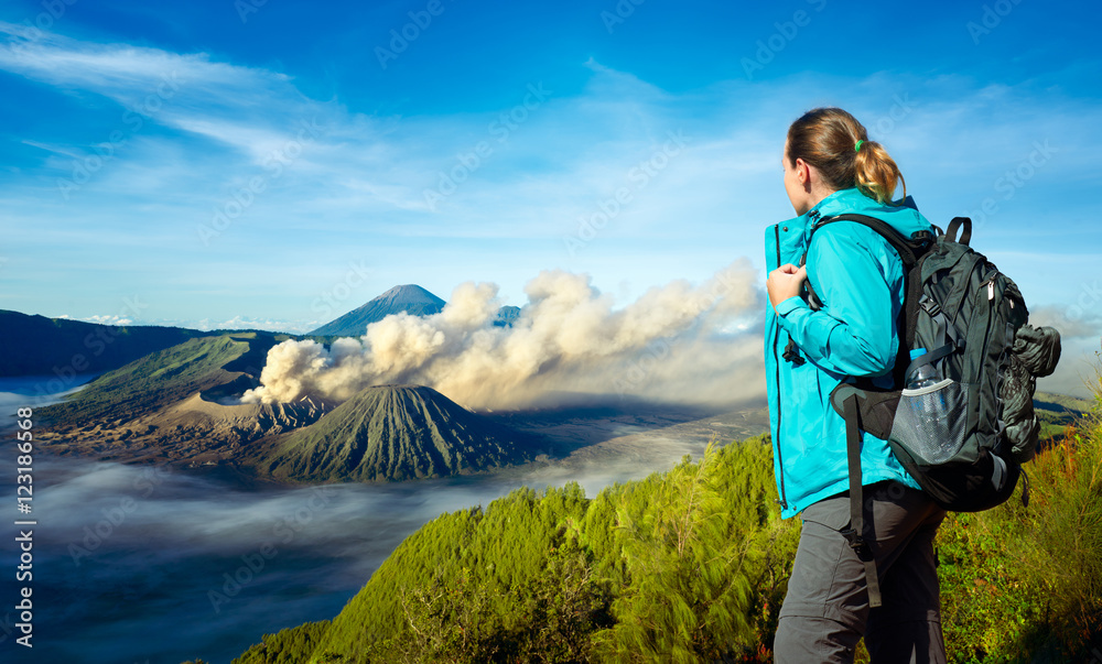 Young woman backpacker enjoying view volcano Bromo