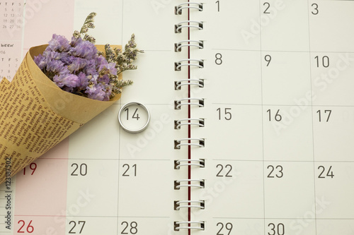 purple flower and ring on calender background