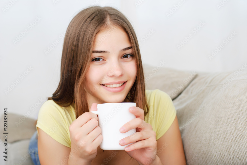 young woman sitting on couch and drinking coffee young woman sitting on couch and drinking coffee