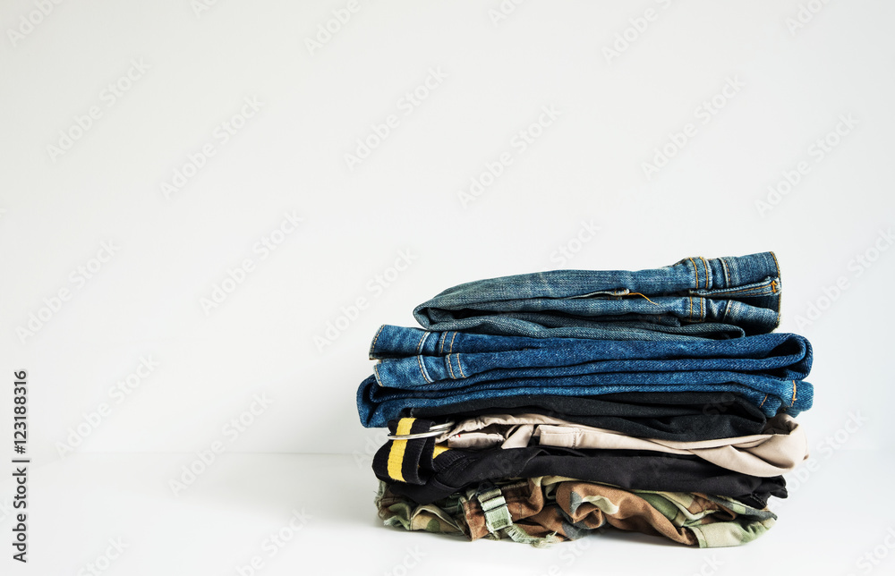 Jeans and Pants Stacked on White Backgrounds Jeans and Pants Stacked on White Backgrounds