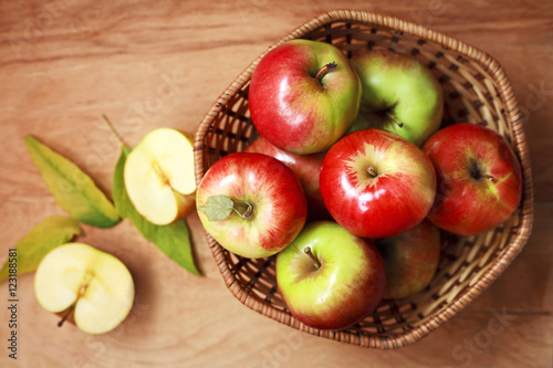 fresh apples in a basket on a wooden table