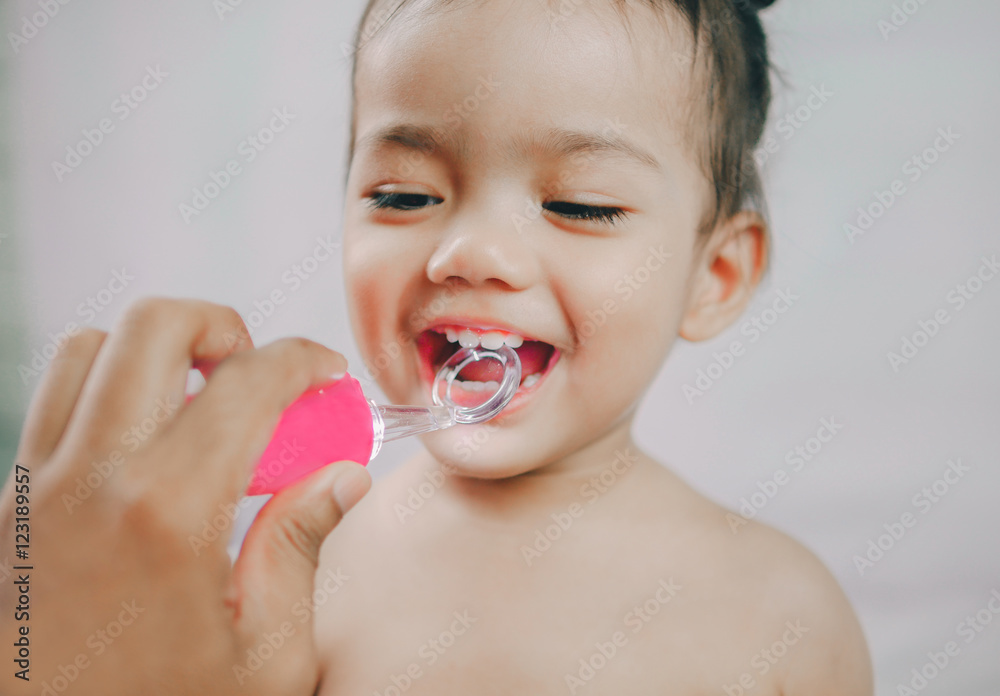 Open mouth of asia little girl during checking tooth and by dent Open mouth of asia little girl during checking tooth and by dent