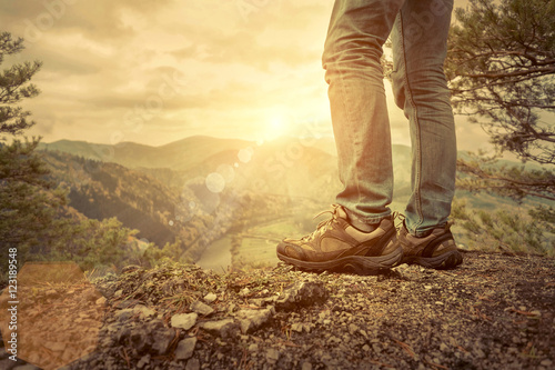 Men stay in Mountains footwear on the beautiful view. © Andrii IURLOV