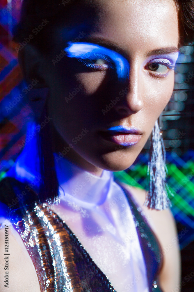 Fashion model beautiful girl in fashionable clothes in ultraviolet light, showing different poses. Beauty body and face. Photos shot in studio Fashion model beautiful girl in fashionable clothes in ultraviolet light, showing different poses. Beauty body and face. Photos shot in studio
