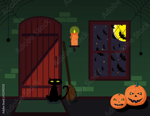 The interior of the witch house with broom, candle, pumpkins and