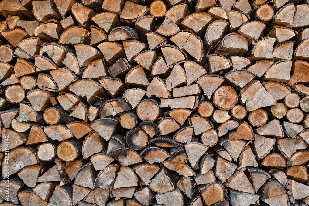 Wooden background, firewood, lumber, a stack of logs Wooden background, firewood, lumber, a stack of logs