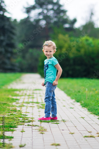 Cute little girl in the park in summer day