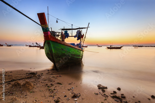 Old fishing boats at sea with sunset