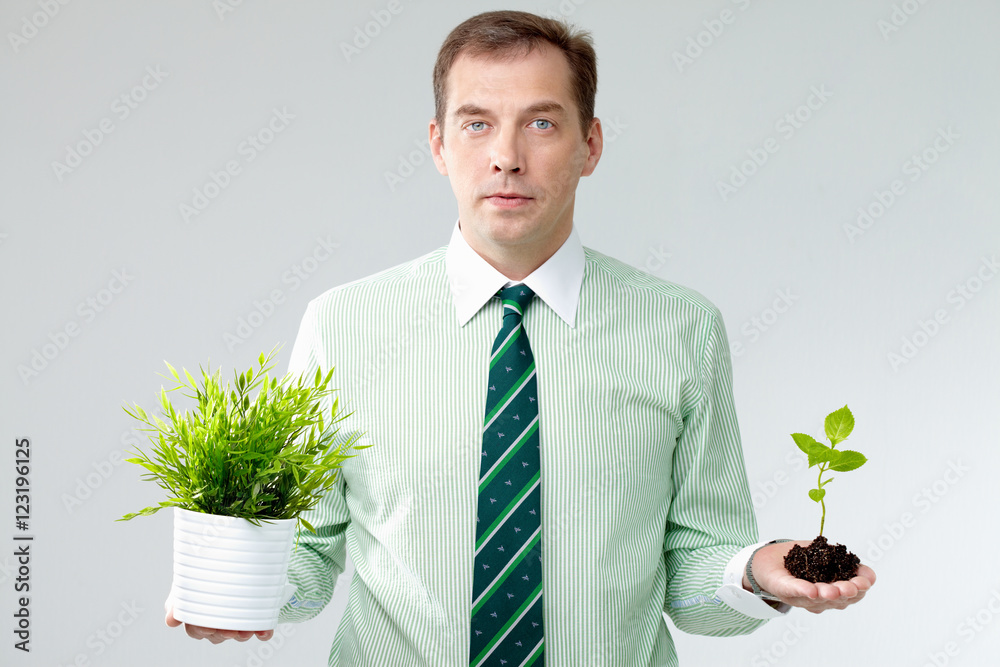 Portrait of a man holding different plants in hands Portrait of a man holding different plants in hands