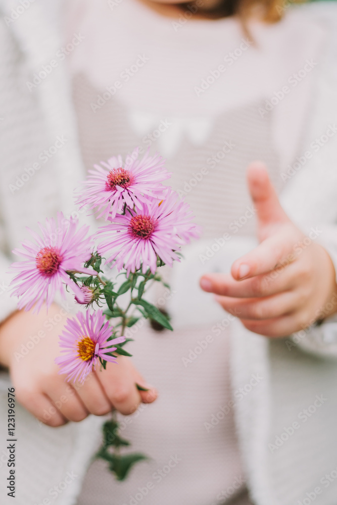 little girl holding flowers in their hands. close-up. without a little girl holding flowers in their hands. close-up. without a