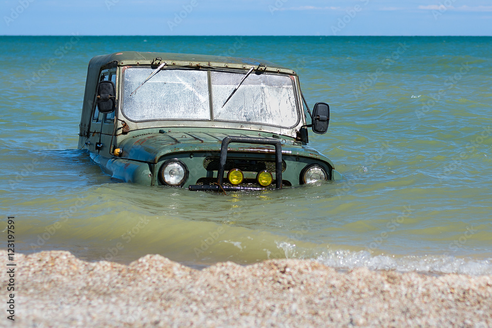 car is sinking in the sea tide