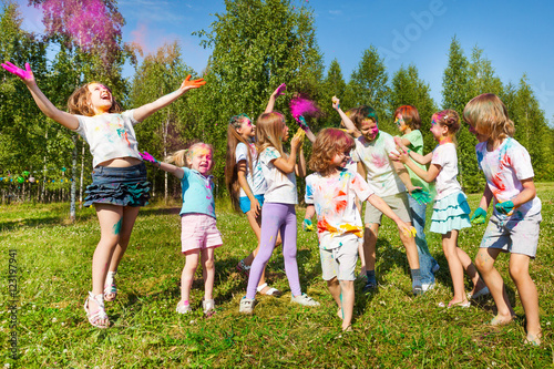 Bright and happy kids playing with colored powder