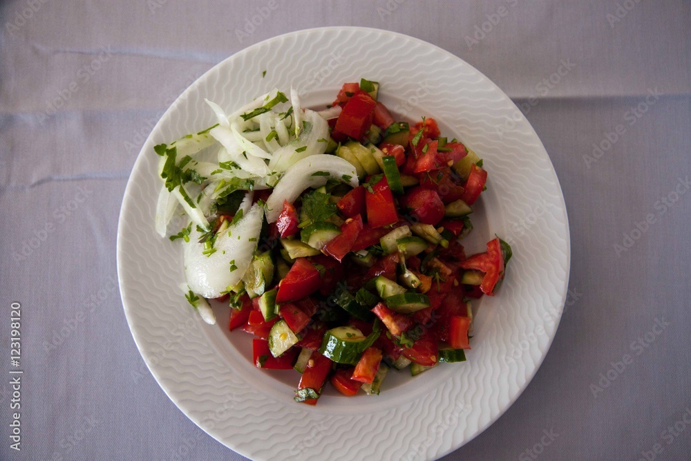 Salad with tomatoes and cucumbers in the plate Salad with tomatoes and cucumbers in the plate