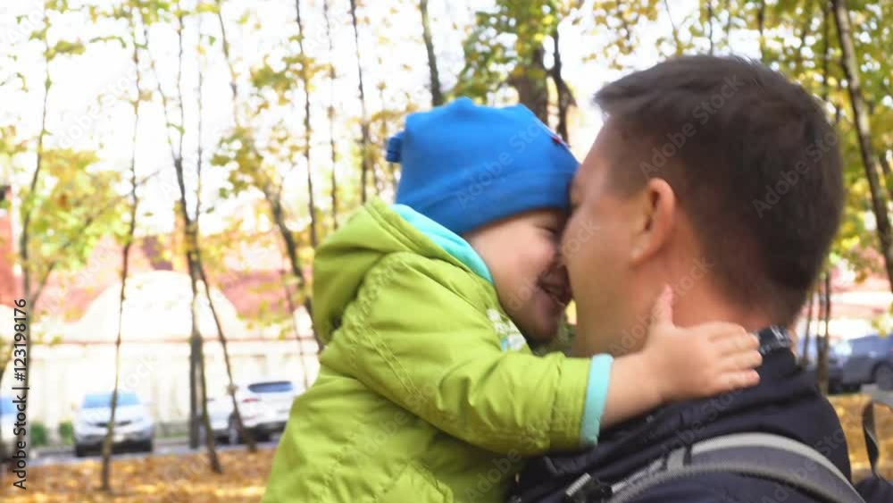 Father and Son Playing in Autumn Park Father and Son Playing in Autumn Park